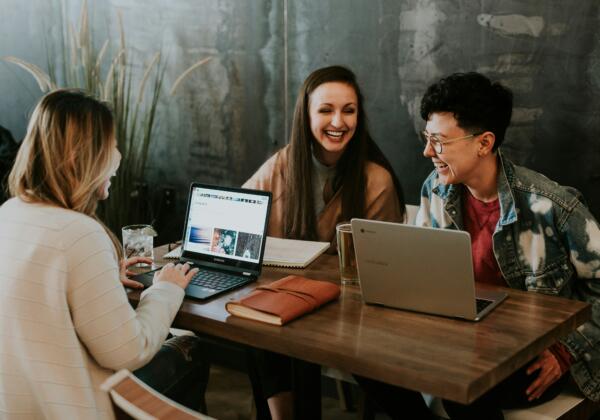 People working and laughing around a table.